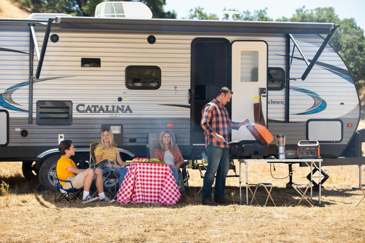 Food sizzling on a Blackstone griddle at an outdoor campsite